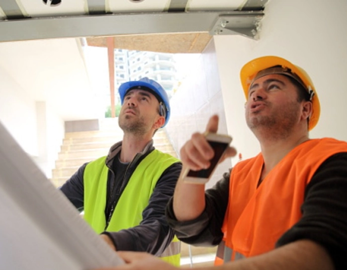Civil engineer reviewing translated bridge specifications on a highway construction site